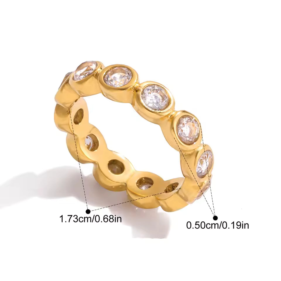 Gold ring with diamonds and measurements on a white background