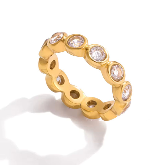 Gold ring with embedded diamonds on a white background