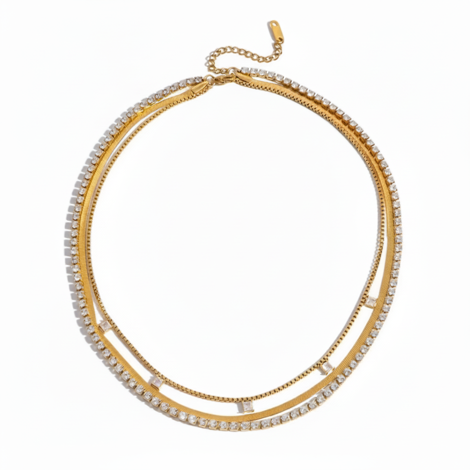 Gold necklace with clear stones on a white background