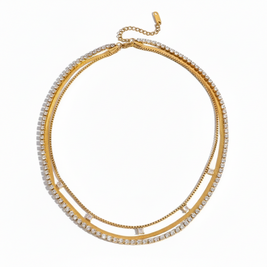 Gold necklace with clear stones on a white background