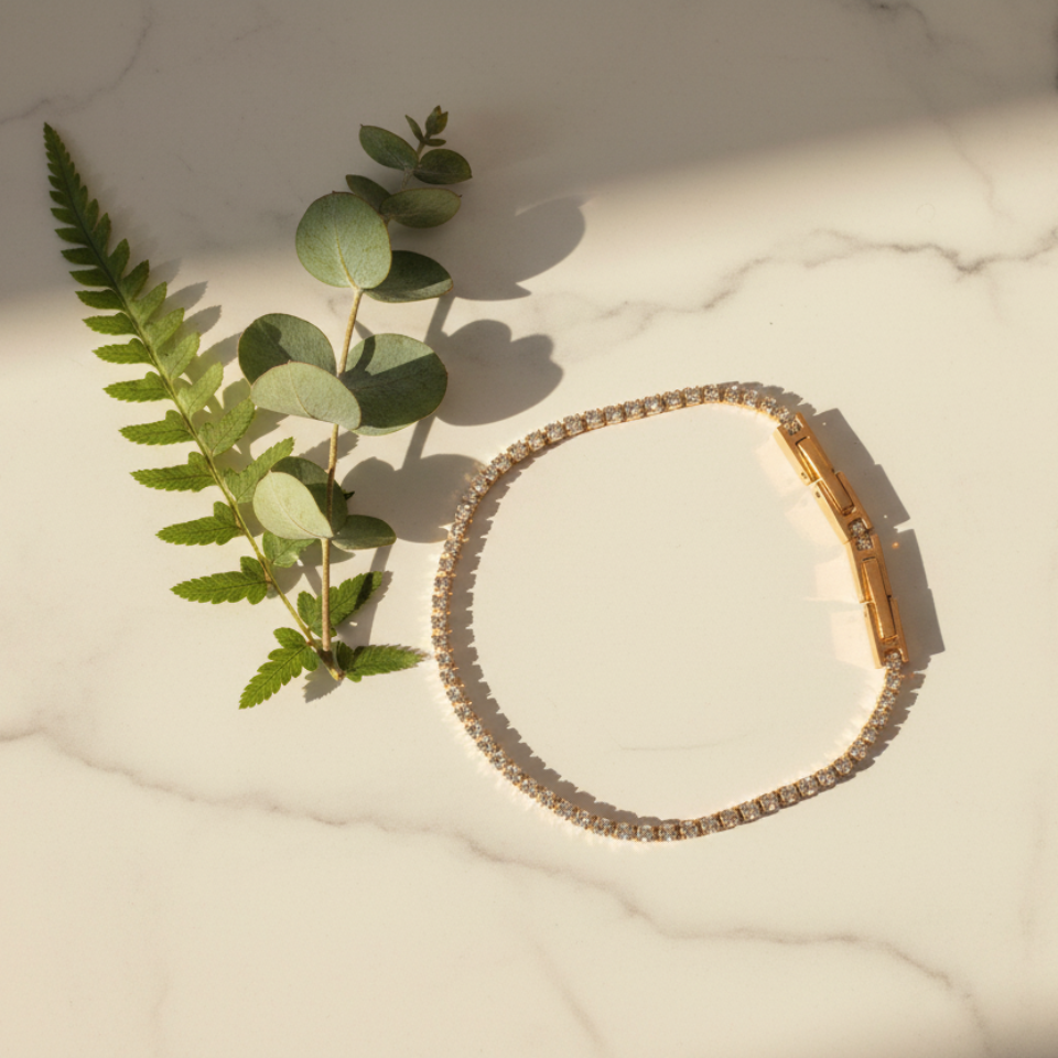 Tennis bracelet on marble with plants - studio flat lay