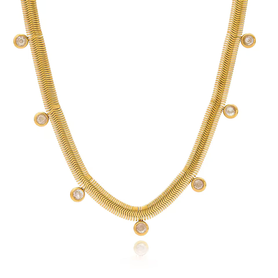 Gold necklace with small round embellishments on a white background