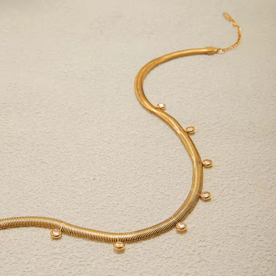 Gold necklace on a beige background