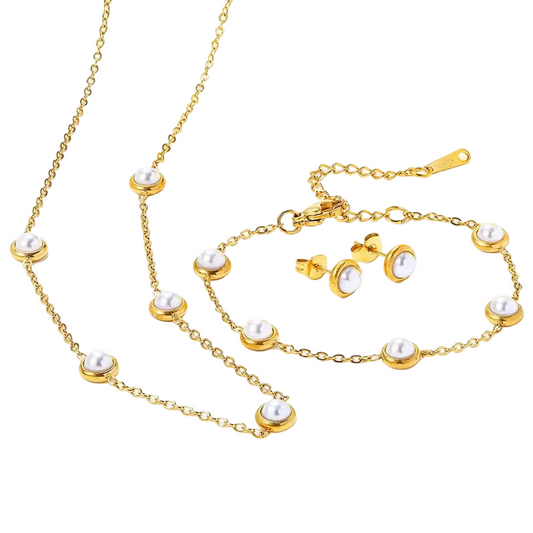 Gold jewelry set with pearls including necklace, bracelet, and earrings on a white background