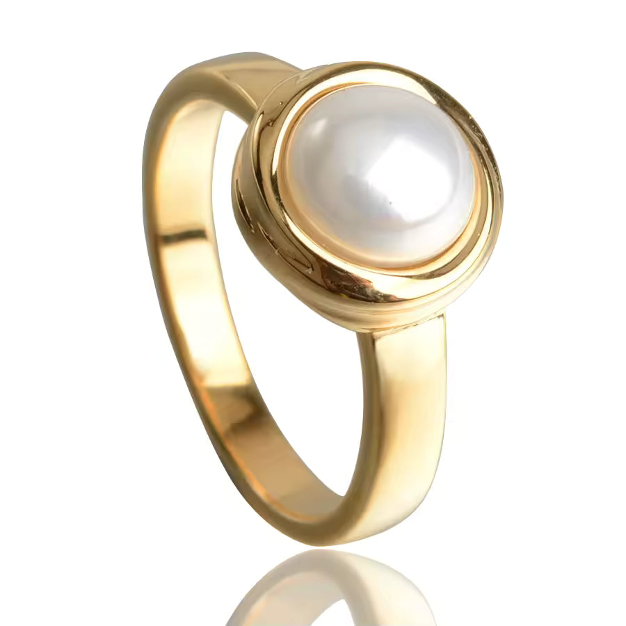 Gold ring with a pearl on a white background