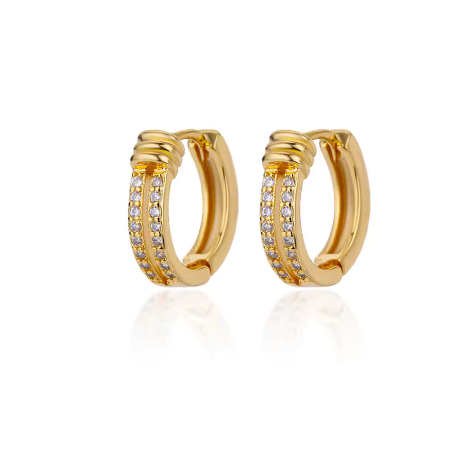 Gold hoop earrings with embedded stones on a white background
