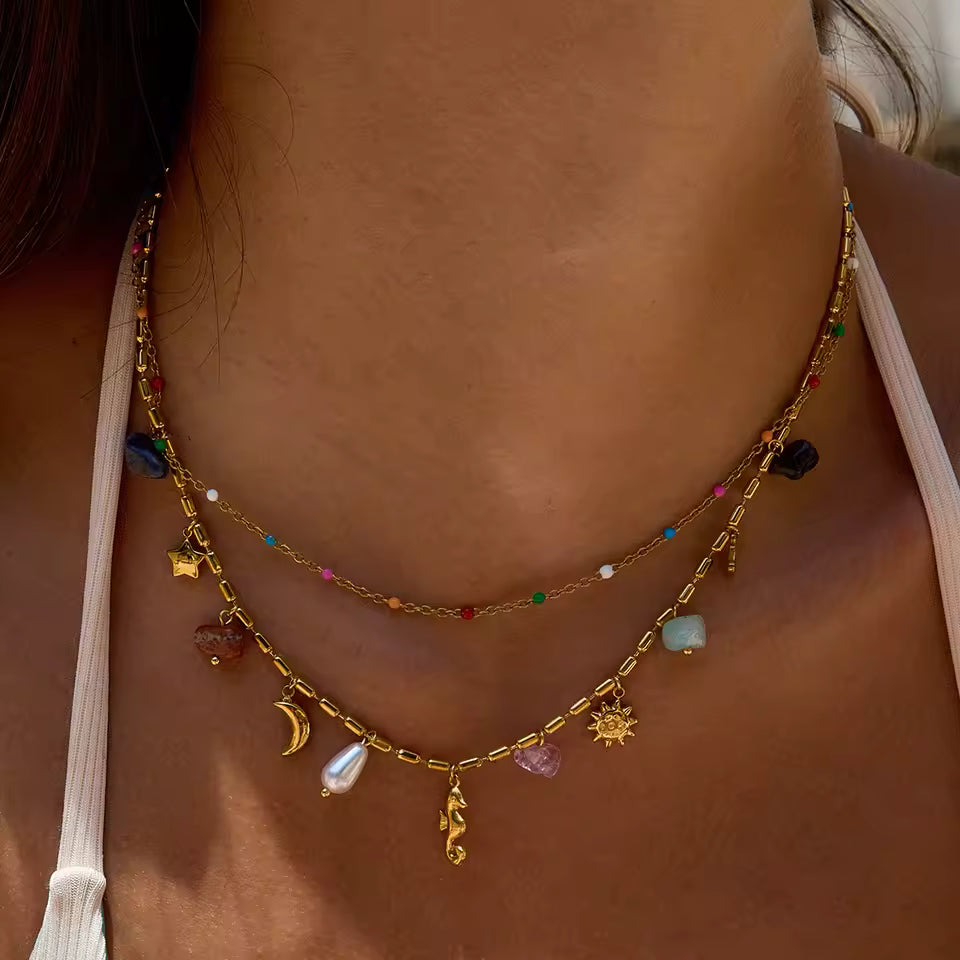 Necklace with various charms on a person's neck