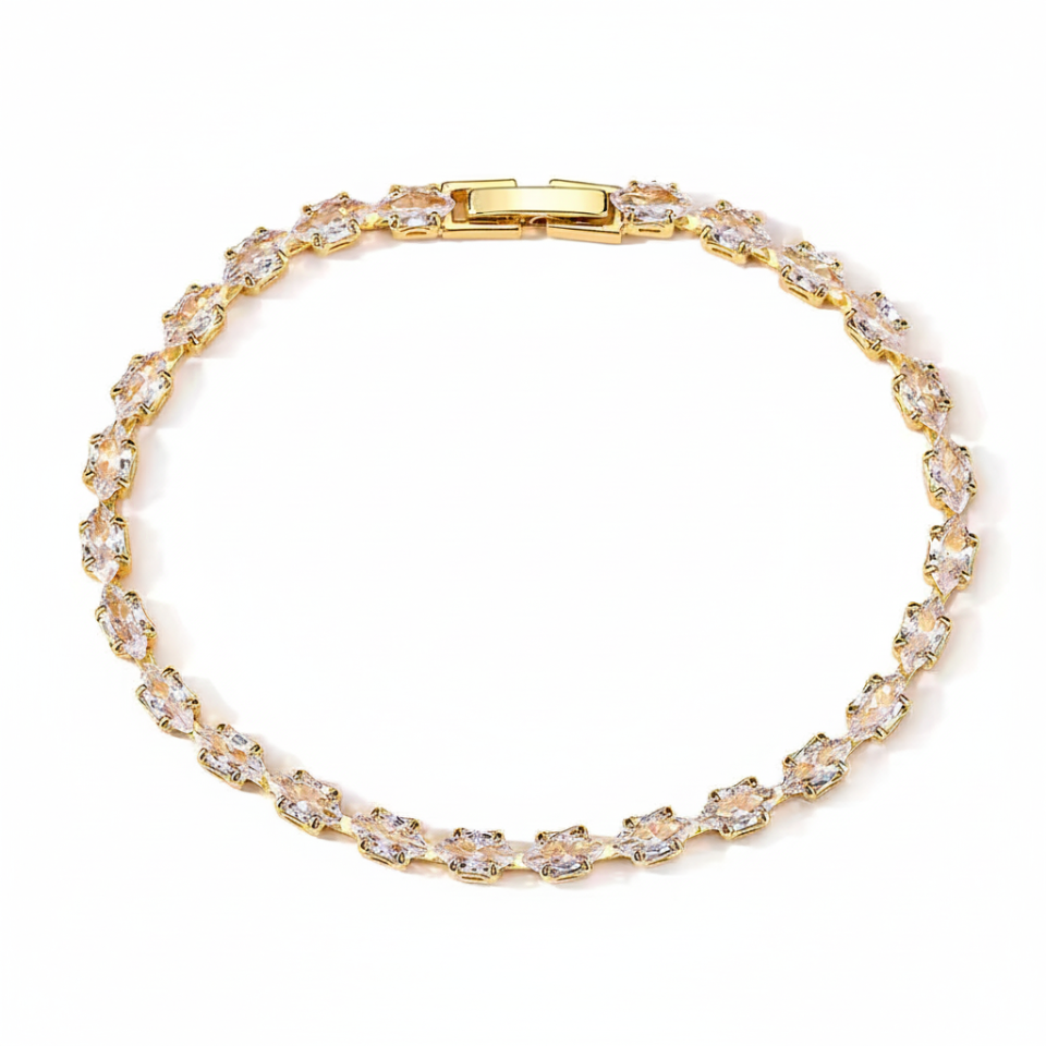 Gold bracelet with clear stones on a white background