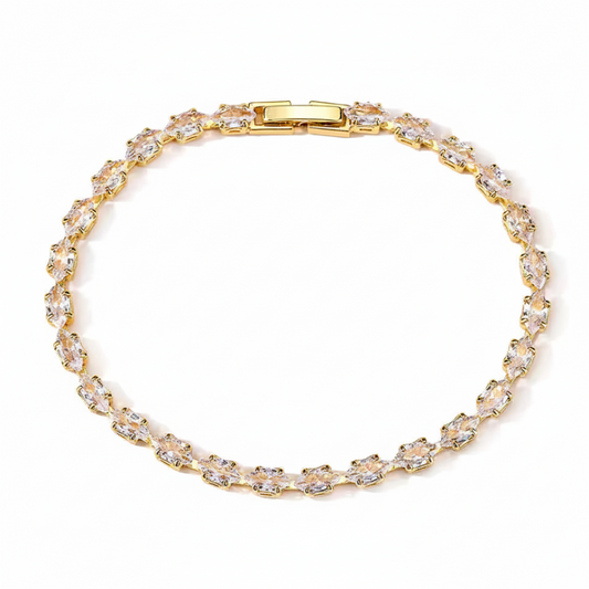 Gold bracelet with clear stones on a white background
