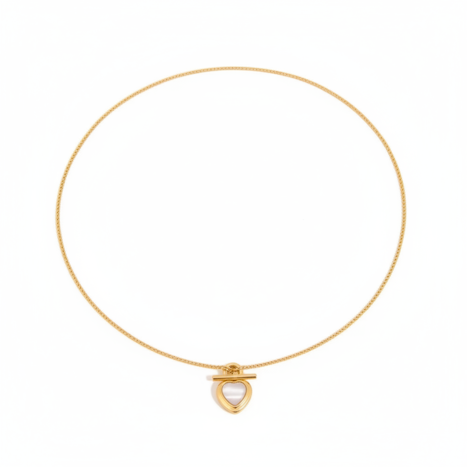 Gold necklace with a heart-shaped pendant on a white background
