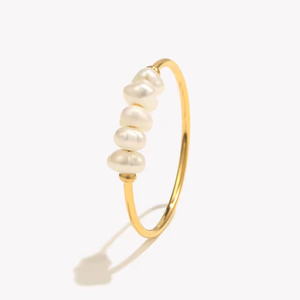 Gold ring with pearls on a white background