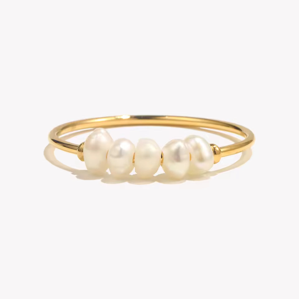 Gold ring with pearls on a white background
