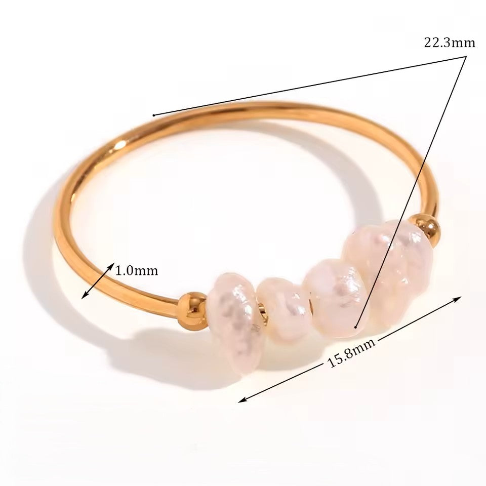 Gold ring with pearls and measurements on a white background