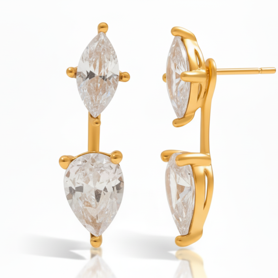 Gold earrings with clear gemstones on a white background
