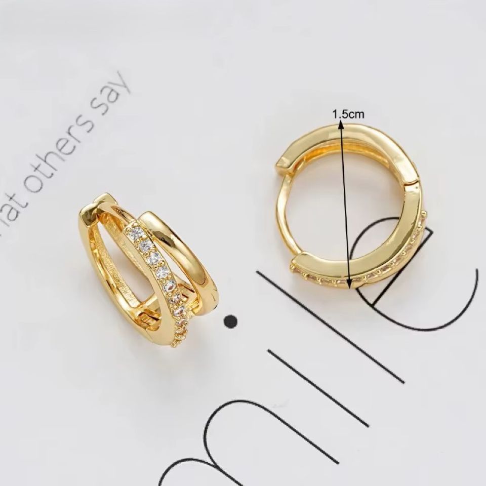 Gold hoop earrings with a measurement label on a white background