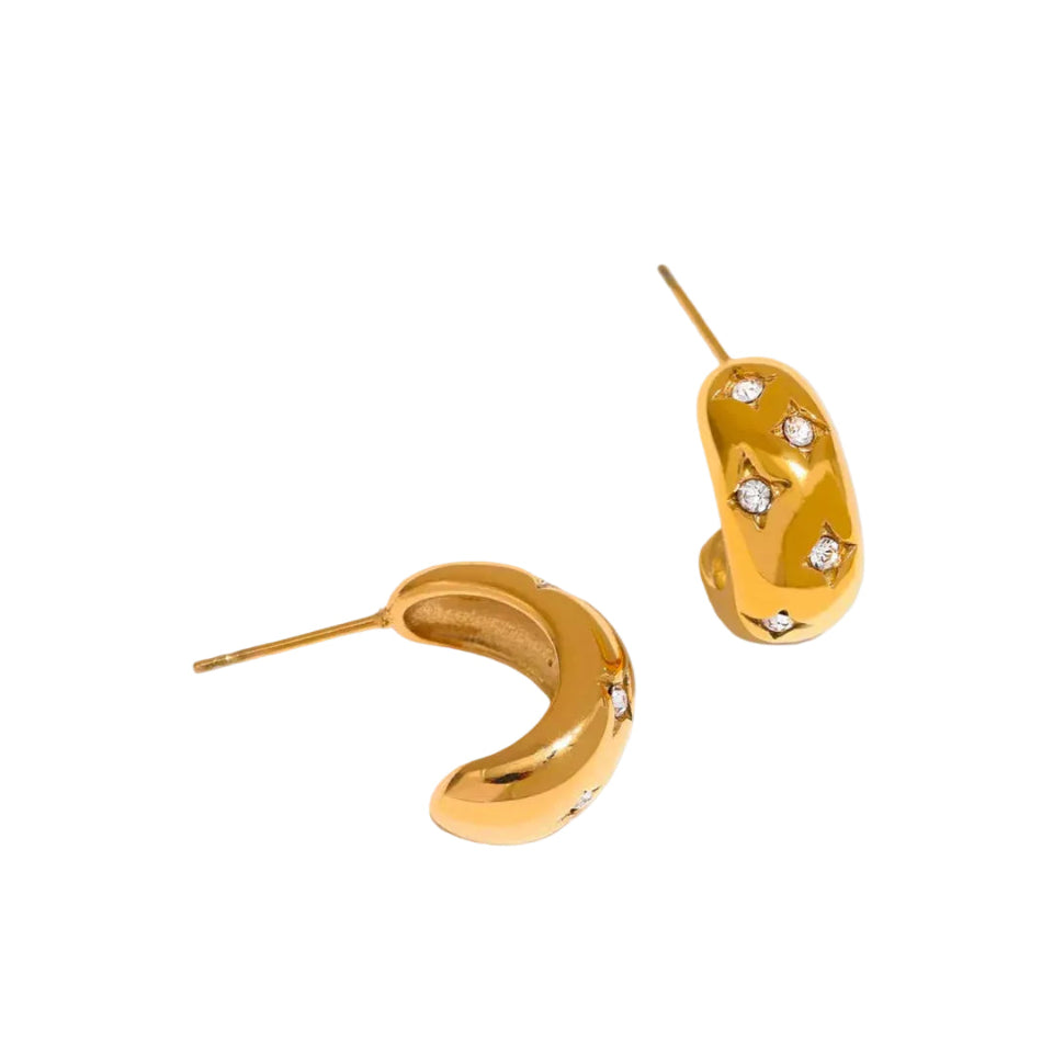 Gold hoop earrings with embedded stones on a light gray background
