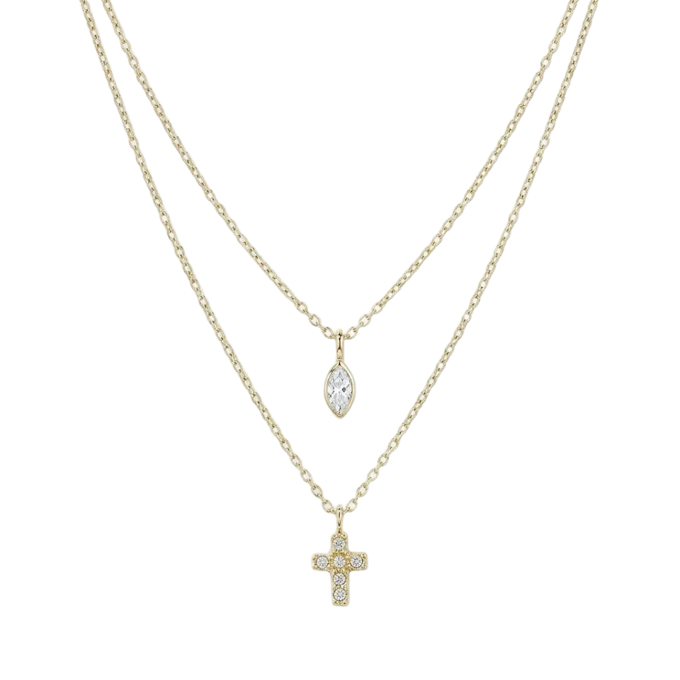 A double-strand gold necklace set featuring a delicate chain with a small cross pendant and a longer chain with a marquise-cut clear crystal pendant, both set with tiny clear stones, shown against a plain white background.