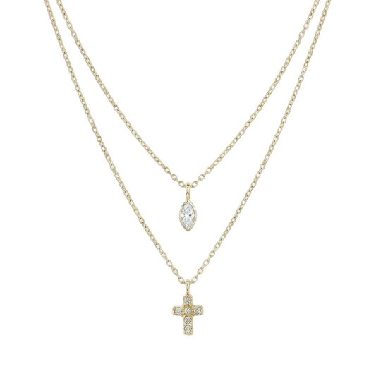 A double-strand gold necklace set featuring a delicate chain with a small cross pendant and a longer chain with a marquise-cut clear crystal pendant, both set with tiny clear stones, shown against a plain white background.
