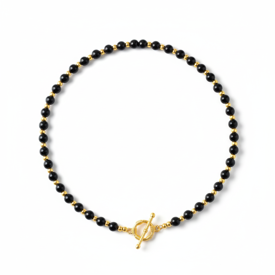 Black beaded necklace with a gold clasp on a white background